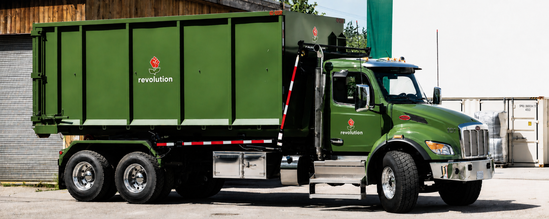 roll-off disposal bin on the back of a truck